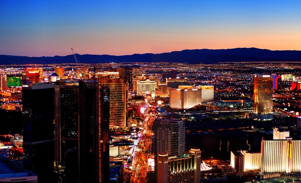 Las Vegas City Skyline panorama with sunset, mountain, luxury hotels and streets.